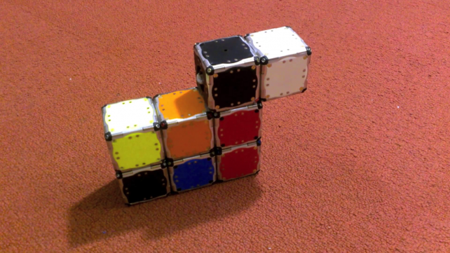 Cube-Shaped Robots Assemble Themselves
